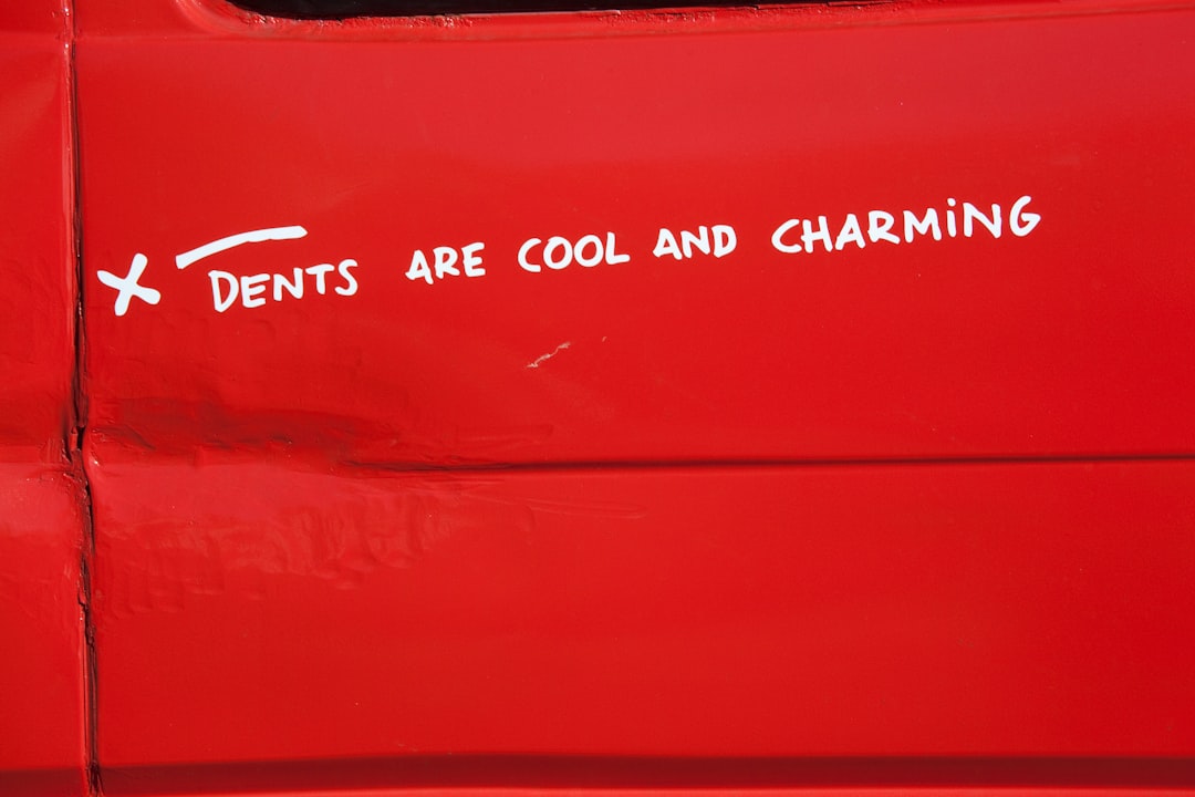 mechanic inspecting car dent